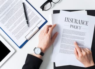Private Flood Insurance vs. FEMA Flood Insurance: What’s the Difference? Business woman examining insurance policy